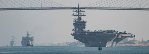 he aircraft carrier USS Dwight D. Eisenhower (CVN 69), followed by the fast combat support ship USNS Arctic (T-AOE 8) and the guided-missile destroyer USS Nitze (DDG 94), pass under the Freedom Bridge while transiting the Suez Canal. 
