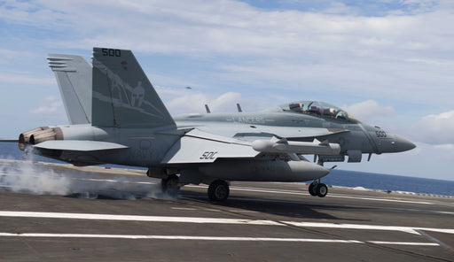 An F/A-18E Hornet attached to the "Lancers" of Electronic Attack Squadron (VAQ) 131 lands on the flight deck of aircraft carrier USS George H.W. Bush (CVN 77)