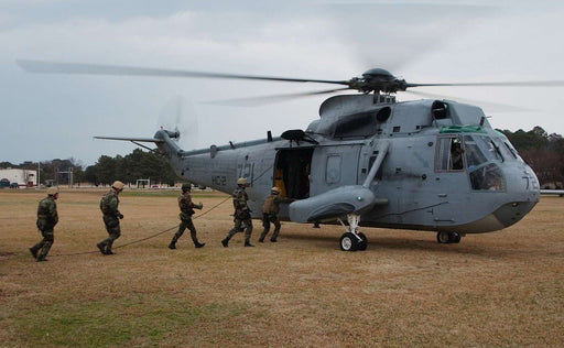 Sailors assigned to Explosive Ordnance Disposal Mobile Unit Two (EODMU-2), board a UH-3H Sea King helicopter, assigned to the Fleet Angels of Helicopter Combat Support Squadron Two (HC-2)