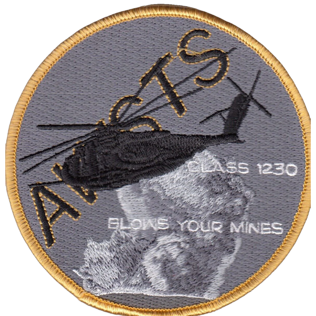 Grey patch with yellow border. "AWSTS" and clouds are background to a helicopter.