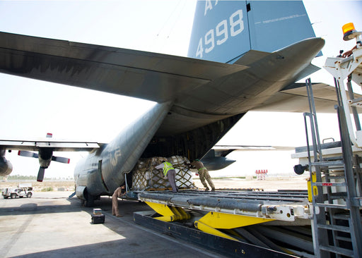 Fleet Logistics Support Squadron 53 guide a pallet aboard a C-130 Hercules in Bahrain.