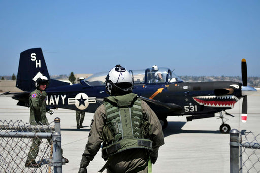 An ROTC midshipman prepares to take a ride in a T-35C training aircraft as part of Career Orientation Training for Midshipmen Aviation Week at Naval Base Coronado